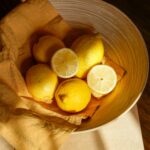 yellow lemon fruit in brown wooden bucket