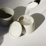 white ceramic mugs on white table